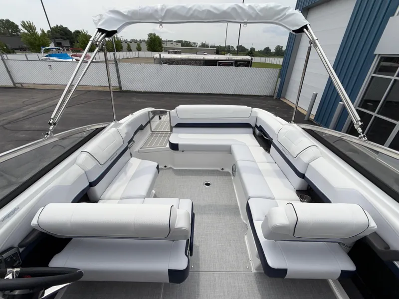 Slide: The Image of 2025 Formula 270 Bowrider with spacious seating and sleek design in a marina setting. - 21