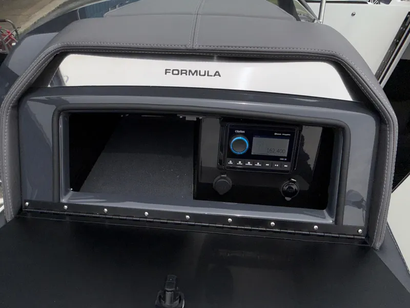 Slide: The Image of 2025 Formula 270 Bowrider dashboard with audio system and storage compartment. - 26