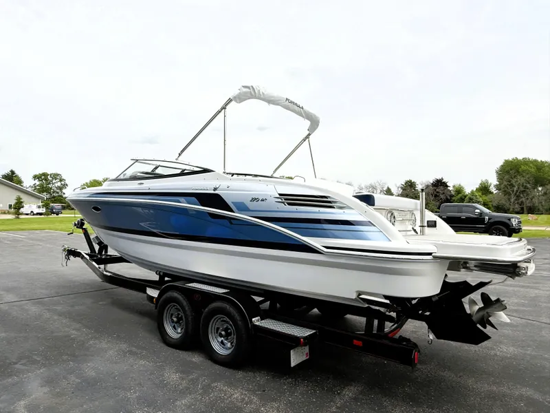 Slide: The Image of 2025 Formula 270 Bowrider boat on trailer, sleek design, blue and white color scheme. - 3