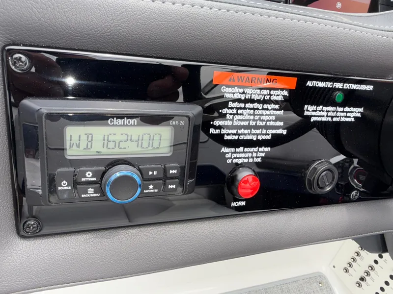 Slide: The Image of Control panel of a 2025 Formula 270 Bowrider with Clarion audio system and safety warnings. - 30