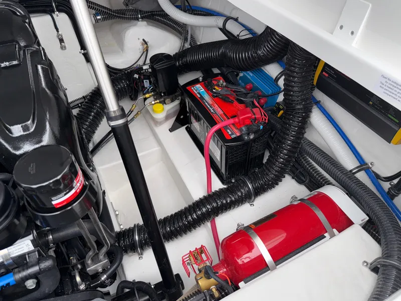 Slide: The Image of Engine compartment of 2025 Formula 270 Bowrider with battery and fire extinguisher. - 33