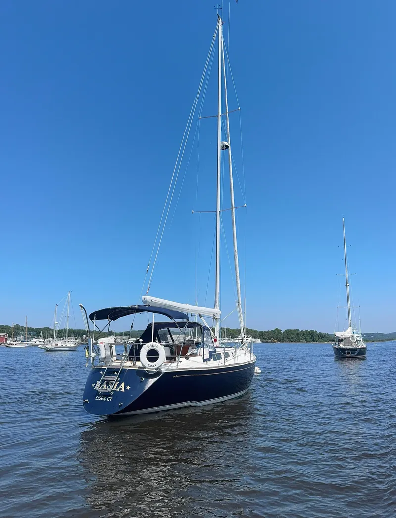 Slide: The Image of 1987 Sabre 42 sailboat on calm water under clear blue sky. - 2
