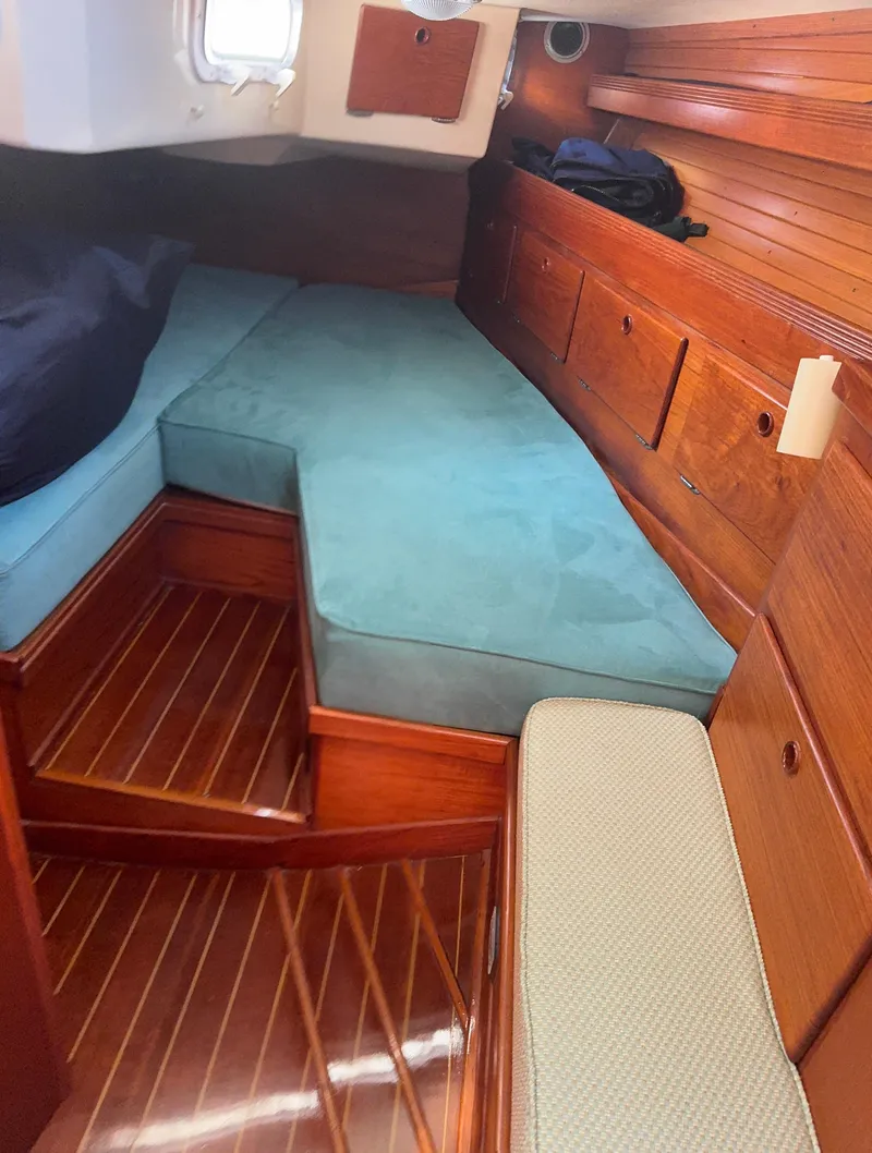 Slide: The Image of Cozy cabin interior of 1987 Sabre 42 sailboat with wooden finish and teal cushions. - 6