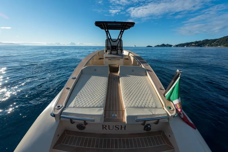 Slide: The Image of AlCustom Levanzo 25 boat on open sea, 2025 model, with Italian flag and clear sky. - 16