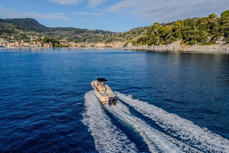 Slide: The Image of AlCustom Levanzo 25 boat cruising on scenic blue waters, 2025 model. - 20