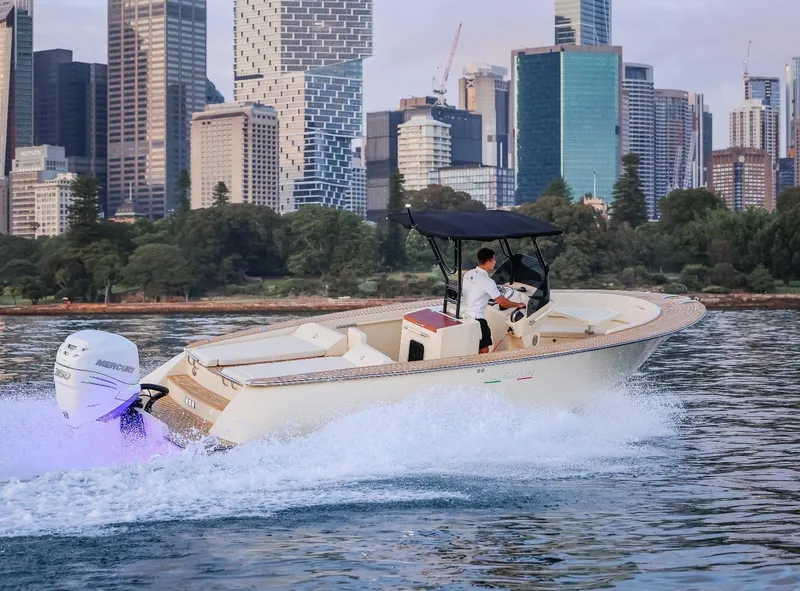 Slide: The Image of AlCustom Levanzo 25 boat cruising near city skyline, 2025 model. - 21