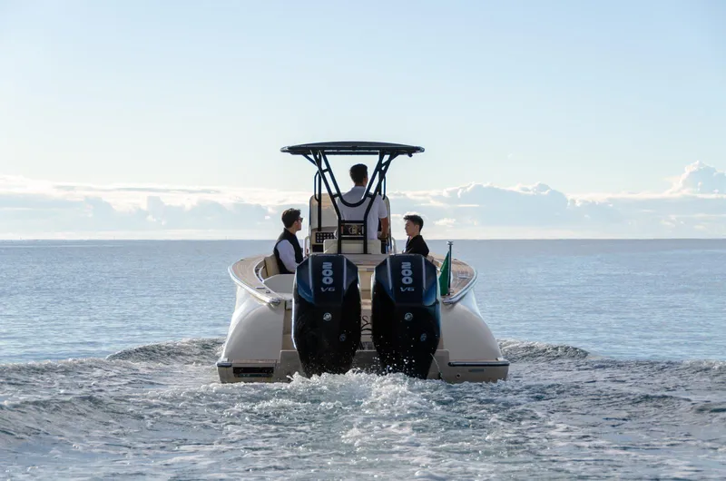 Slide: The Image of 2025 AlCustom Levanzo 25 boat with dual engines cruising on open water. - 6