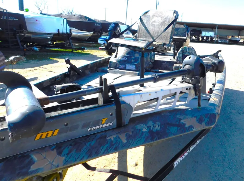 Slide: The Image of 2016 Triton 17 C TX boat with camo design and trolling motor. - 7