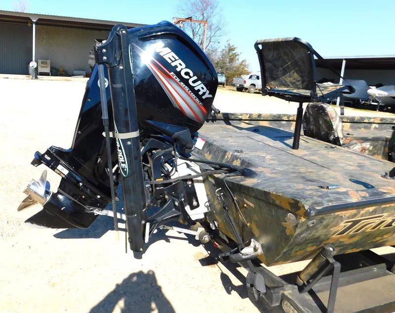 Slide: The Image of 2016 Triton 17 C TX boat with Mercury outboard motor, parked outdoors. - 8