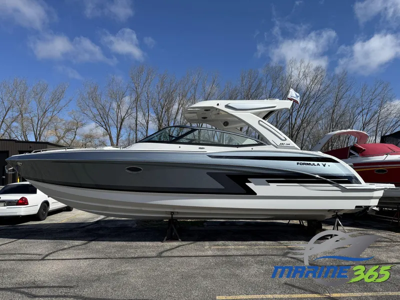 The Image of 2025 Formula 330 Crossover Bowrider I/O boat displayed outdoors on a sunny day. - 0