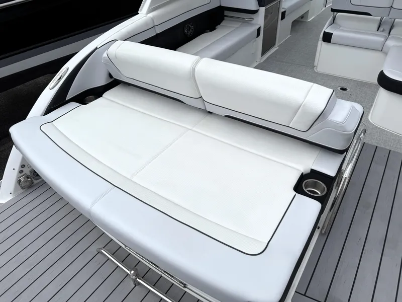 Slide: The Image of 2025 Formula 330 Crossover Bowrider I/O with sleek white seating and modern deck design. - 10