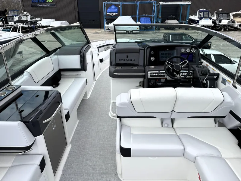 Slide: The Image of 2025 Formula 330 Crossover Bowrider I/O interior with modern seating and control panel. - 14