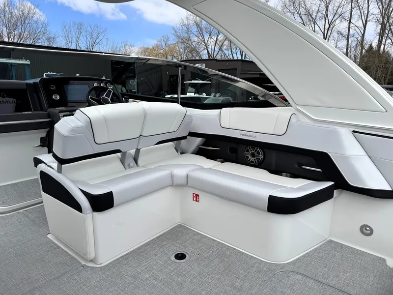 Slide: The Image of 2025 Formula 330 Crossover Bowrider I/O with sleek white seating and modern dashboard. - 15
