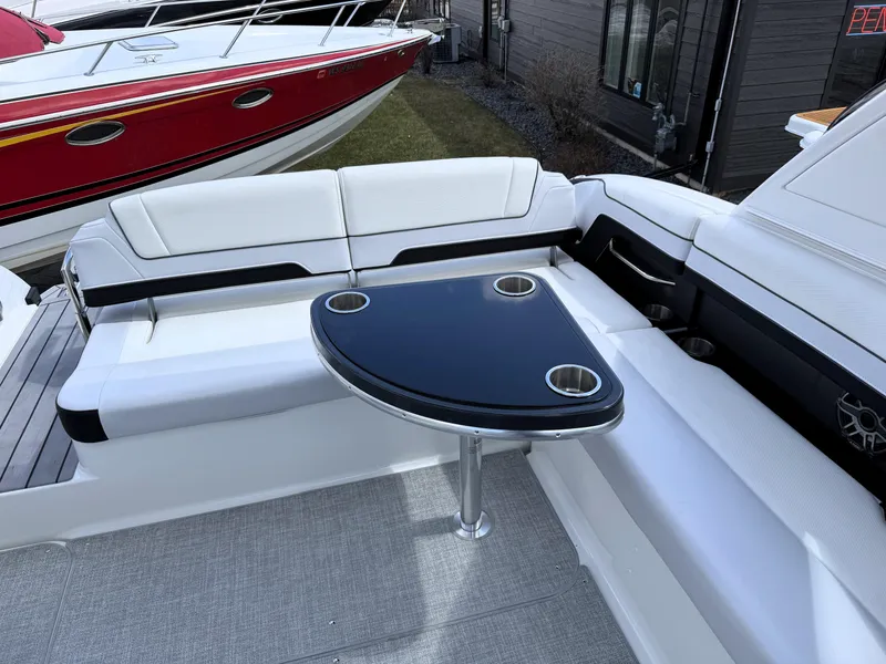 Slide: The Image of 2025 Formula 330 Crossover Bowrider I/O with sleek seating and modern table design. - 20