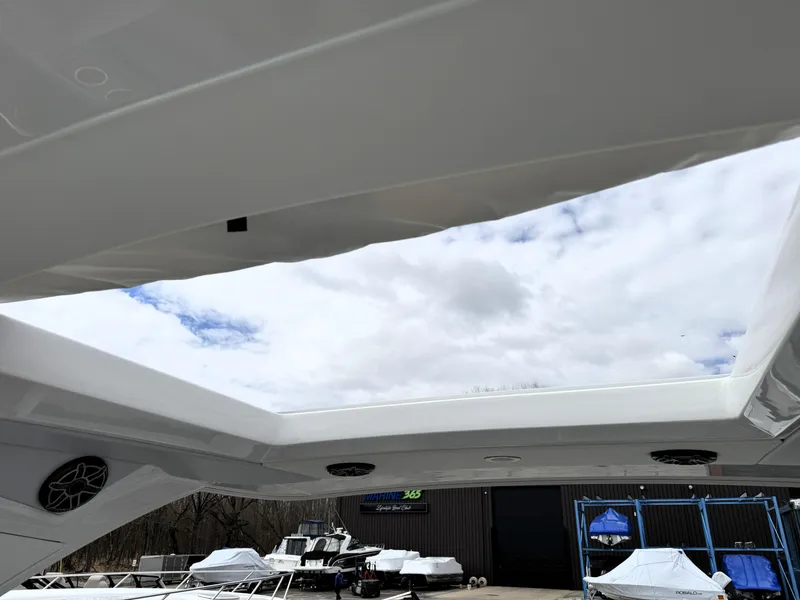 Slide: The Image of Rooftop view from 2025 Formula 330 Crossover Bowrider I/O, showcasing sky and boatyard. - 30