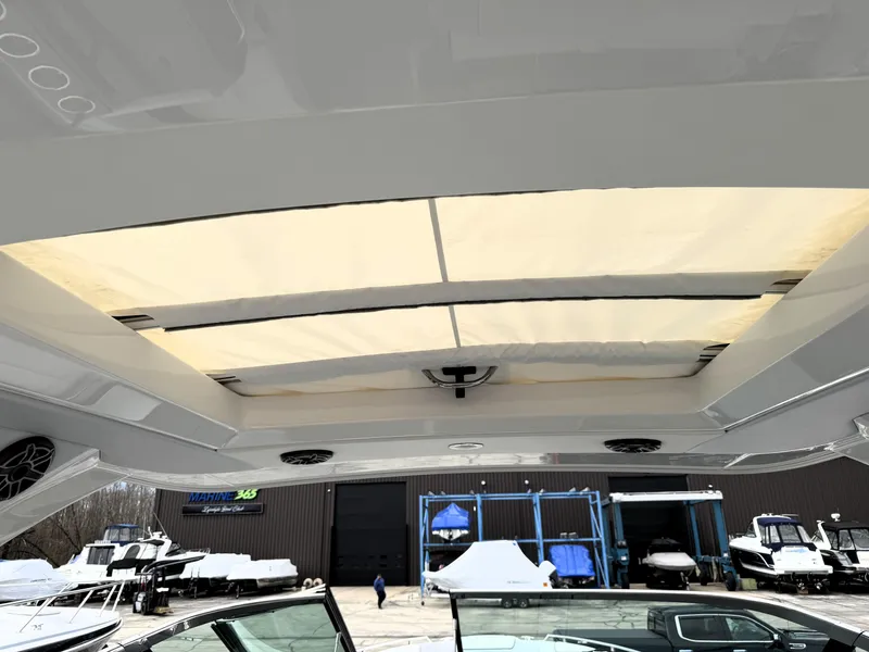 Slide: The Image of 2025 Formula 330 Crossover Bowrider I/O with sunroof and marina background. - 31