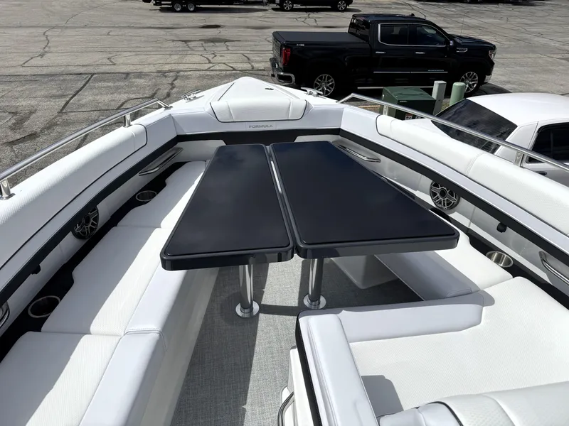 Slide: The Image of 2025 Formula 330 Crossover Bowrider I/O with sleek seating and dual tables. - 39