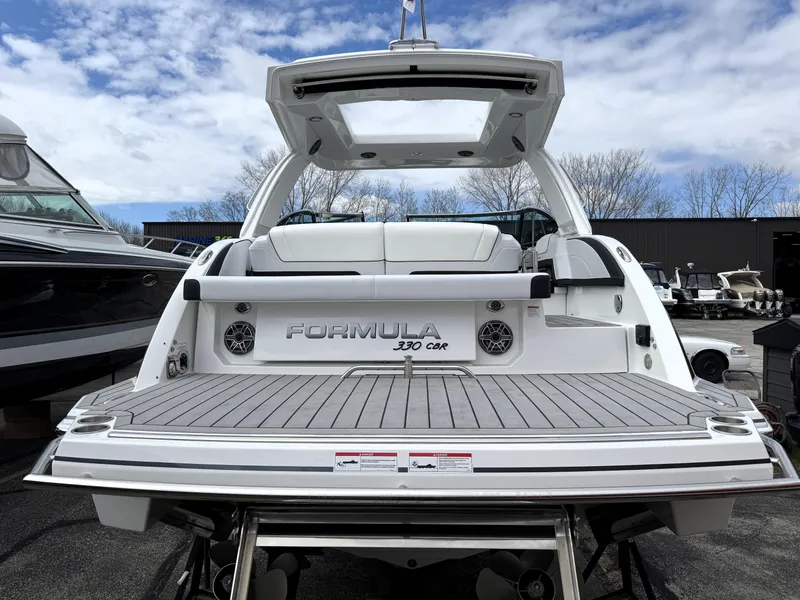Slide: The Image of 2025 Formula 330 Crossover Bowrider I/O, rear view, showcasing spacious deck and sleek design. - 4