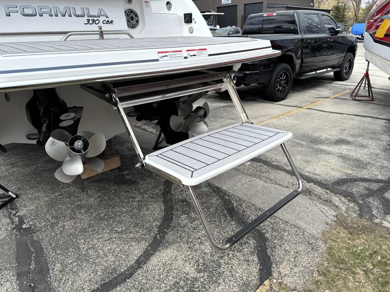 Slide: The Image of 2025 Formula 330 Crossover Bowrider I/O with extended swim platform and dual propellers. - 5