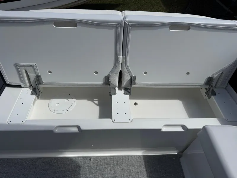 Slide: The Image of 2025 Formula 330 Crossover Bowrider I/O storage compartment with open lids. - 6