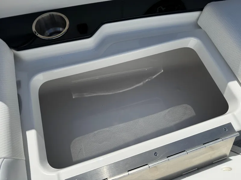 Slide: The Image of 2025 Formula 330 Crossover Bowrider I/O storage compartment with cup holder detail. - 8