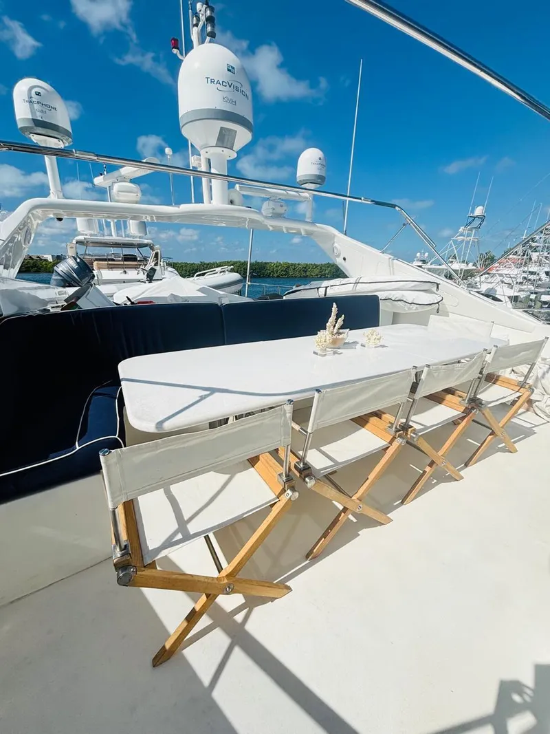Slide: The Image of Luxurious Falcon Motoryacht 2000 with elegant outdoor dining area under clear blue skies. - 10