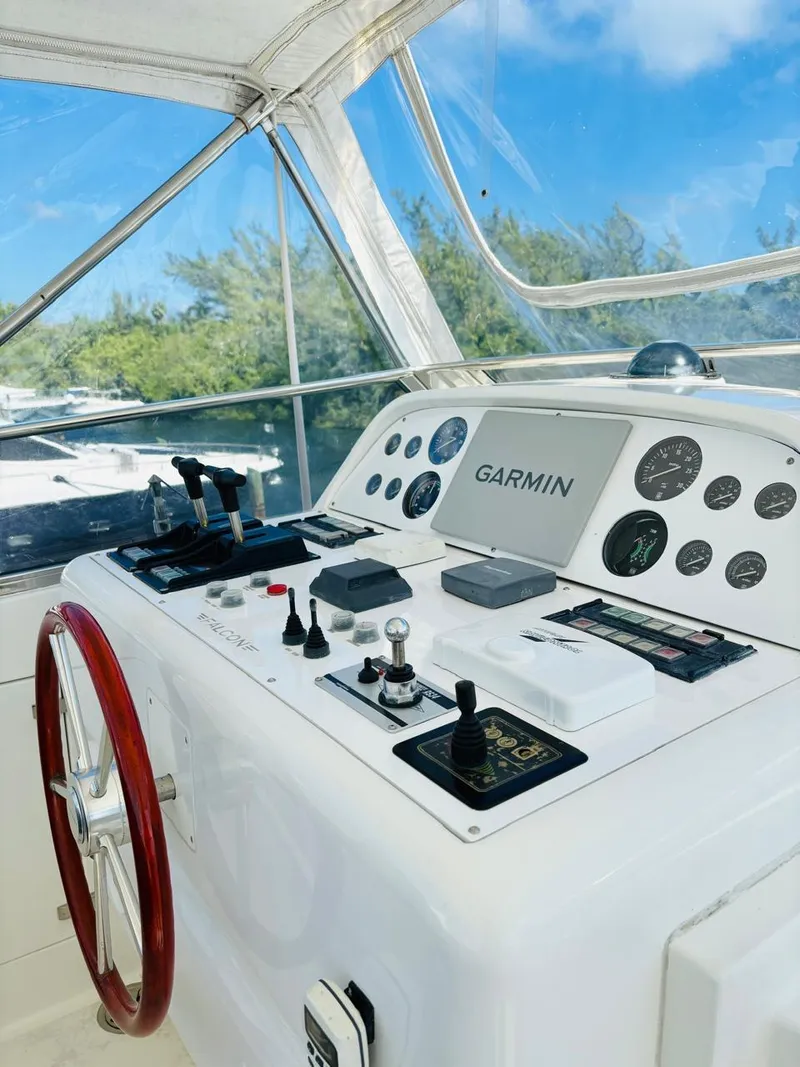 Slide: The Image of Cockpit of 2000 Falcon Motoryacht with Garmin navigation system and red steering wheel. - 14