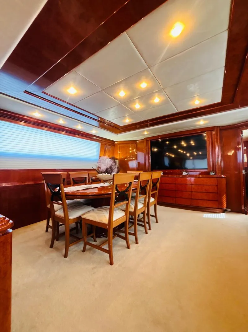 Slide: The Image of Luxurious dining area on a 2000 Falcon Motoryacht with elegant wood finishes. - 21