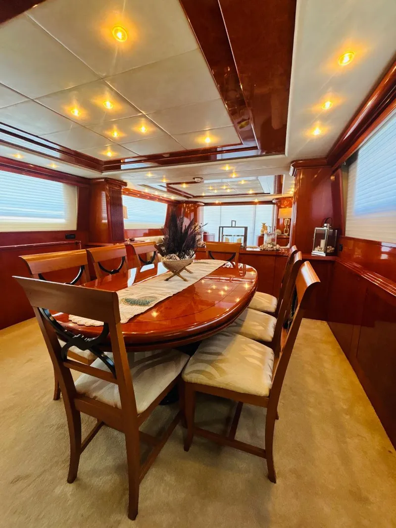 Slide: The Image of Luxurious dining area on a 2000 Falcon Motoryacht with elegant wood finishes and ambient lighting. - 22