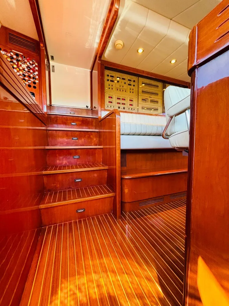 Slide: The Image of Luxurious wooden interior of a 2000 Falcon Motoryacht, featuring polished stairs and control panels. - 24