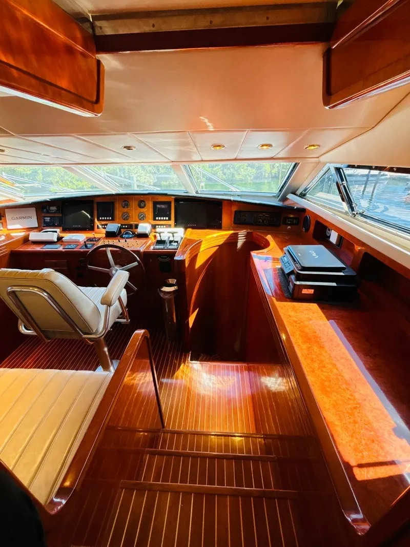 Slide: The Image of Luxurious 2000 Falcon Motoryacht interior with polished wood and modern navigation equipment. - 25