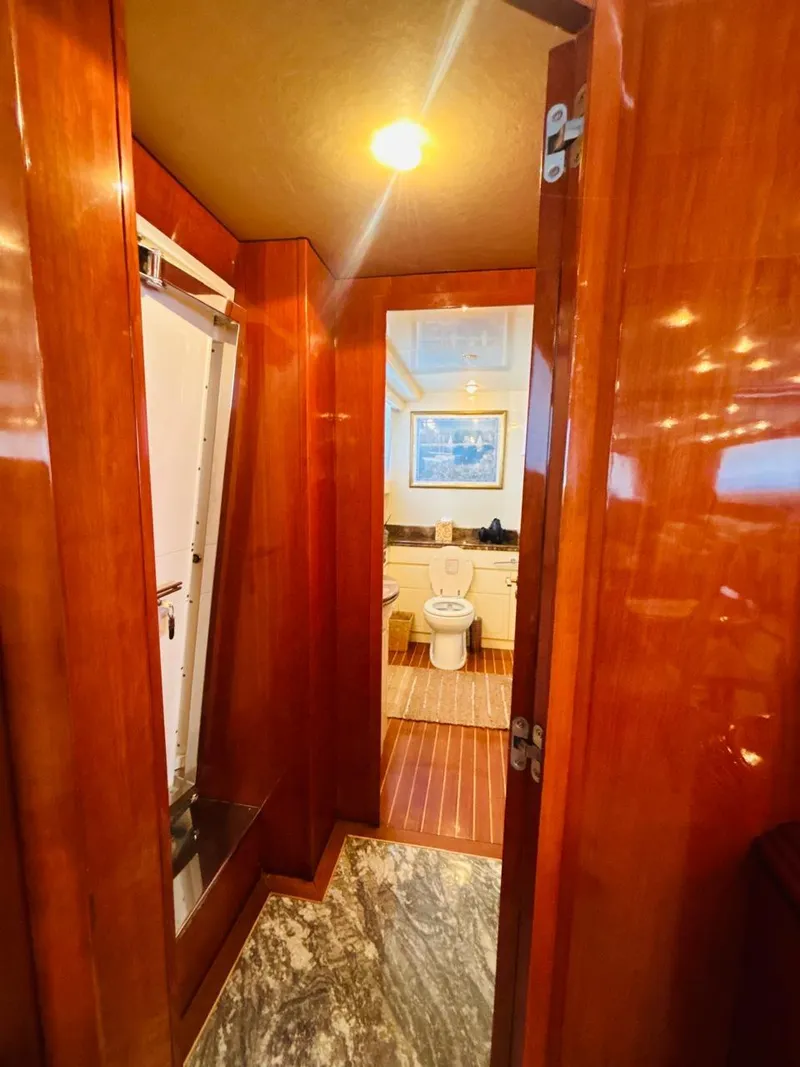 Slide: The Image of Luxurious bathroom interior on 2000 Falcon Motoryacht with wooden finishes and marble flooring. - 29