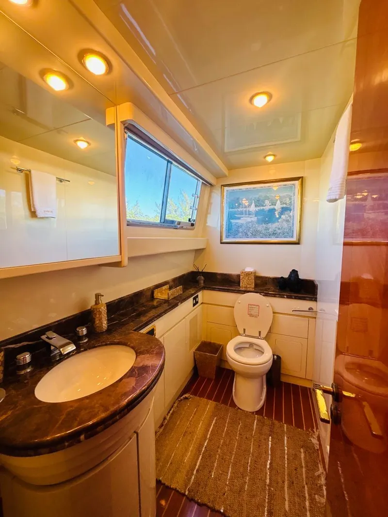 Slide: The Image of Luxurious bathroom on 2000 Falcon Motoryacht with elegant fixtures and natural lighting. - 30
