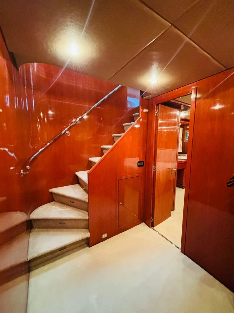 Slide: The Image of Luxurious interior of 2000 Falcon Motoryacht with polished wood and elegant staircase. - 31