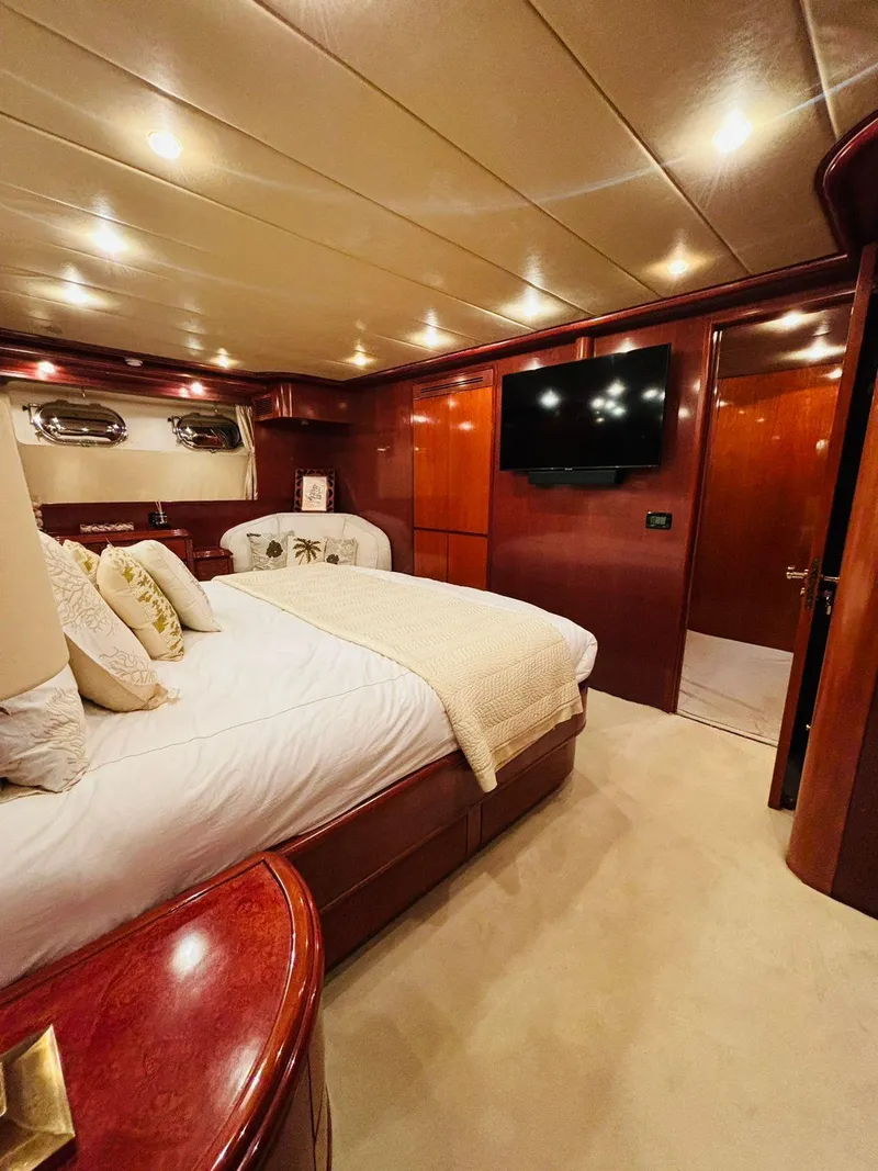 Slide: The Image of Luxurious bedroom in 2000 Falcon Motoryacht with elegant wood finishes and modern amenities. - 34