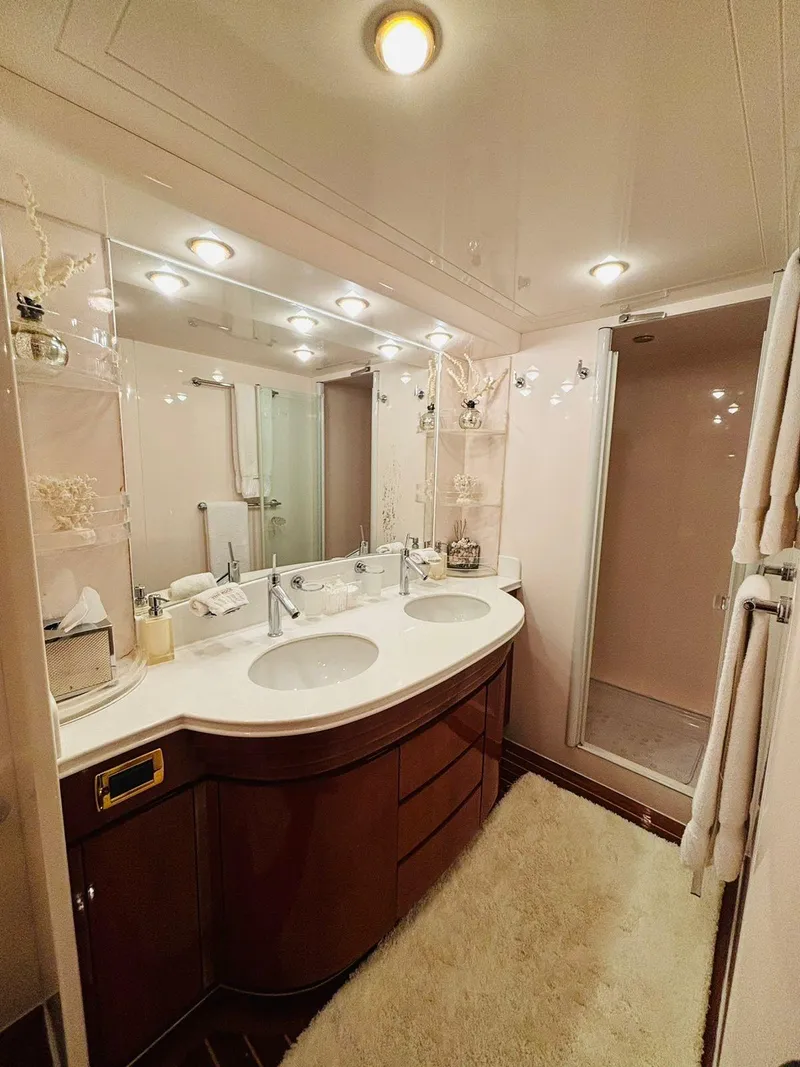 Slide: The Image of Luxurious bathroom in a 2000 Falcon Motoryacht with double sinks and elegant lighting. - 36