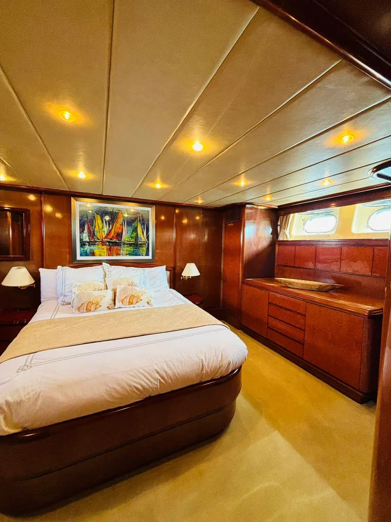 Slide: The Image of Luxurious bedroom interior of 2000 Falcon Motoryacht with elegant wood finishes and ambient lighting. - 39