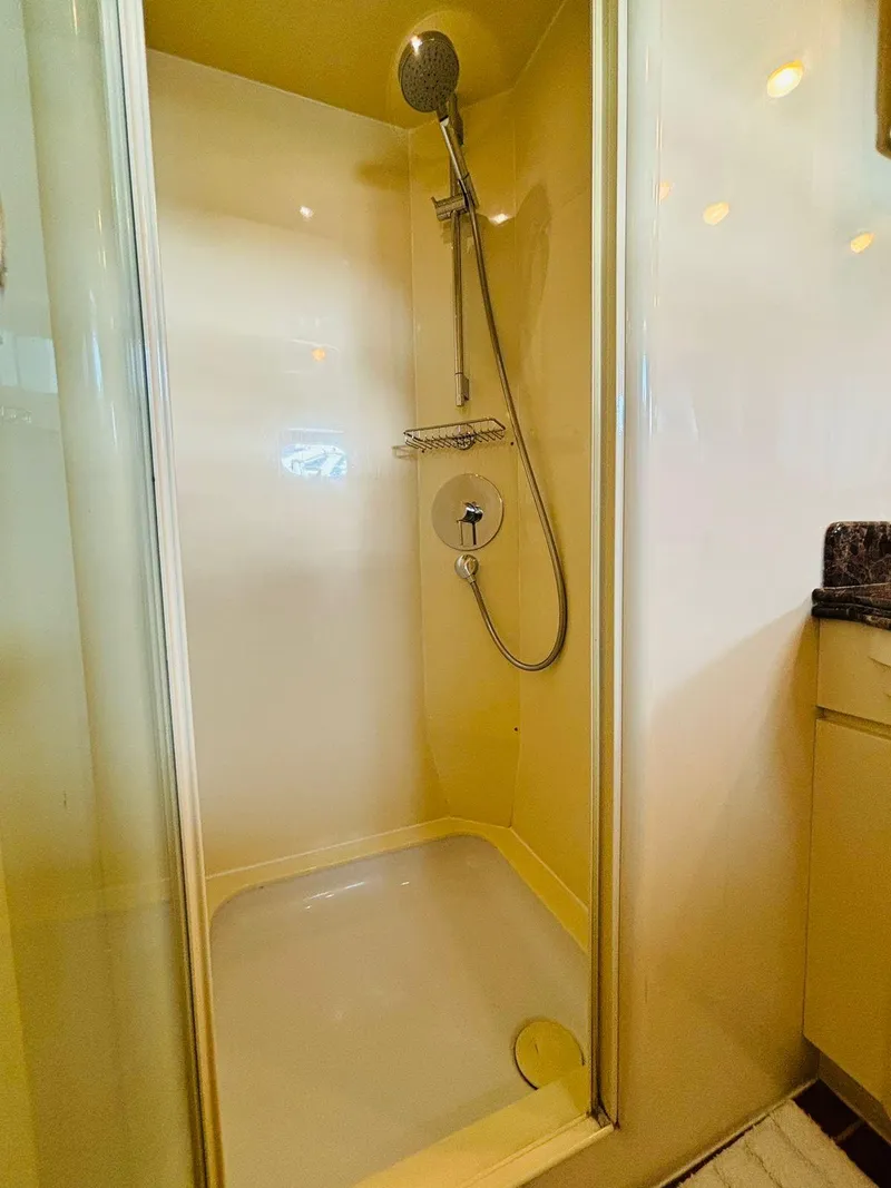 Slide: The Image of Shower area in 2000 Falcon Motoryacht, featuring sleek design and modern fixtures. - 42