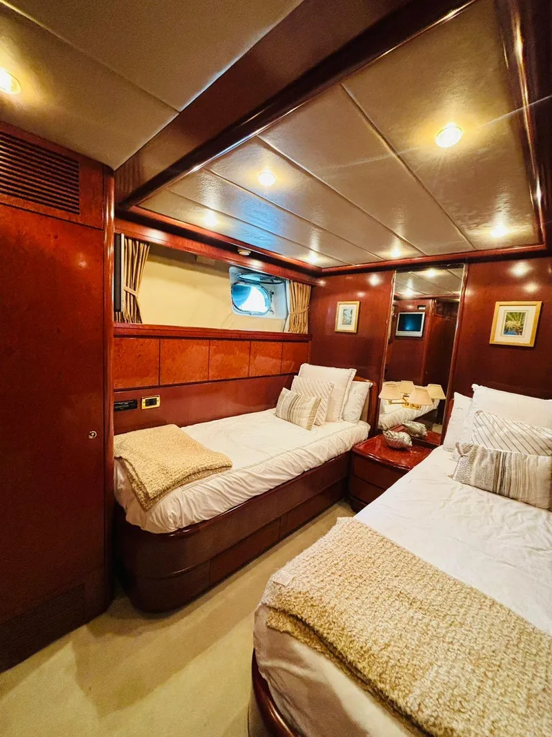 Slide: The Image of Luxurious cabin interior of 2000 Falcon Motoryacht with twin beds and elegant wood finish. - 43