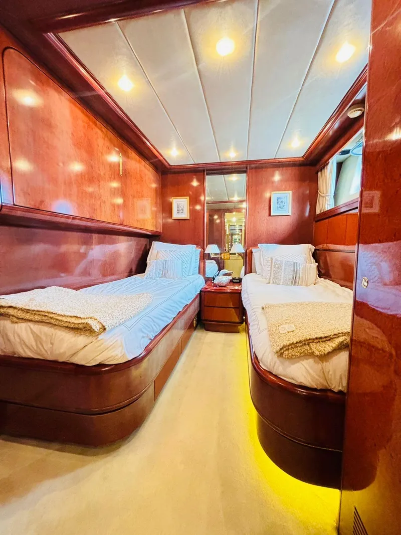 Slide: The Image of Luxurious twin cabin on 2000 Falcon Motoryacht with elegant wood paneling and ambient lighting. - 46