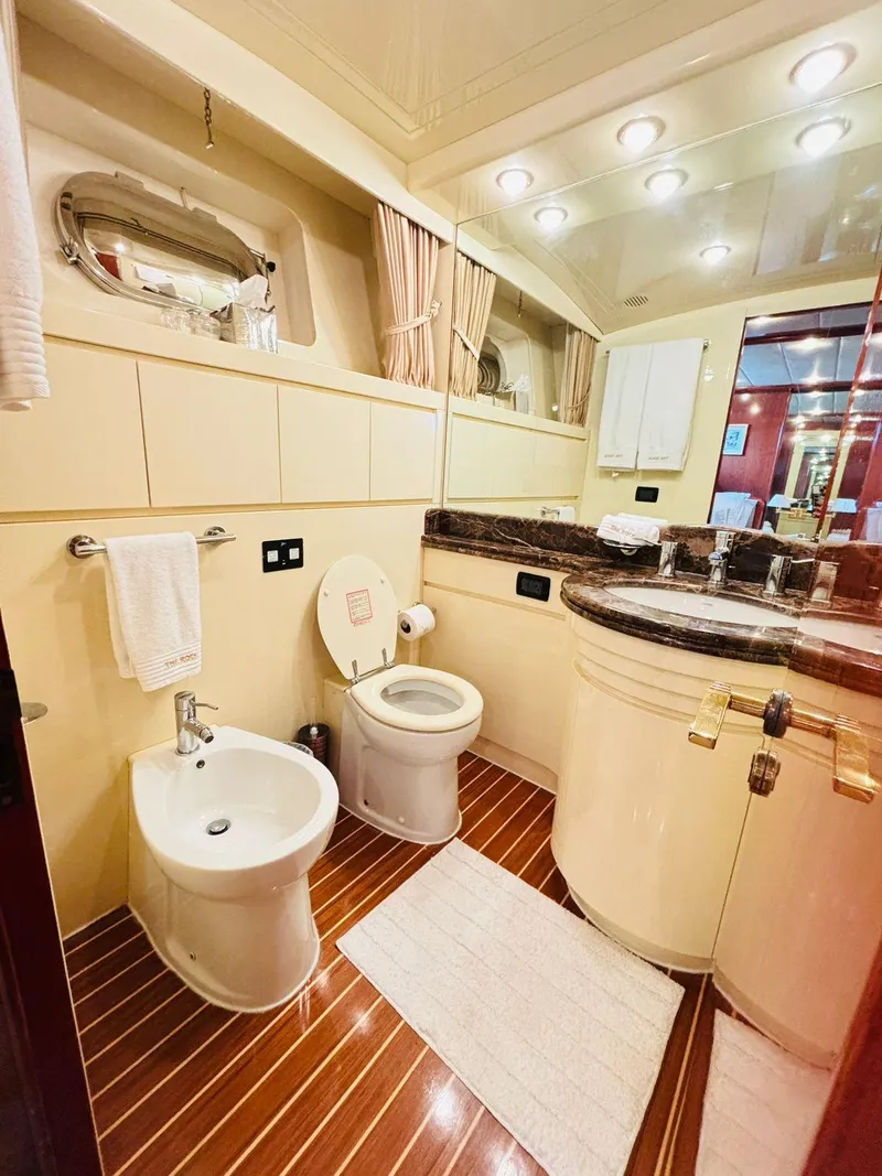 Slide: The Image of Luxurious bathroom in 2000 Falcon Motoryacht with elegant fixtures and wooden flooring. - 48