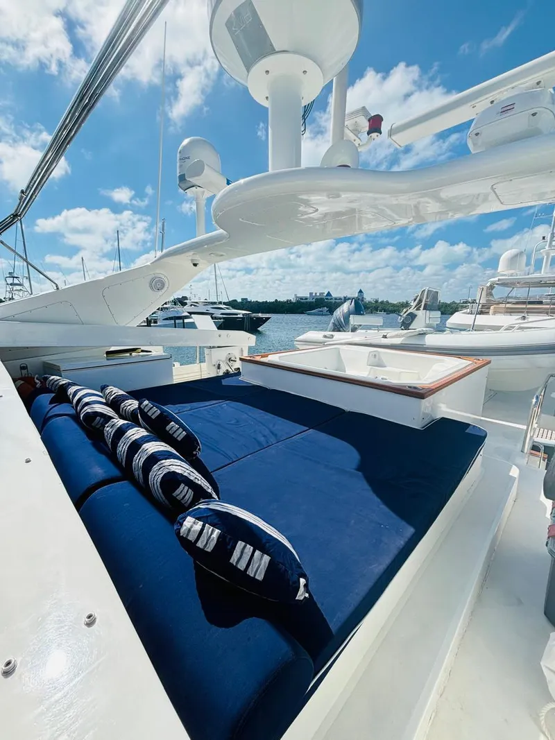 Slide: The Image of Luxurious Falcon Motoryacht 2000 with sun deck, blue cushions, and marina view. - 8