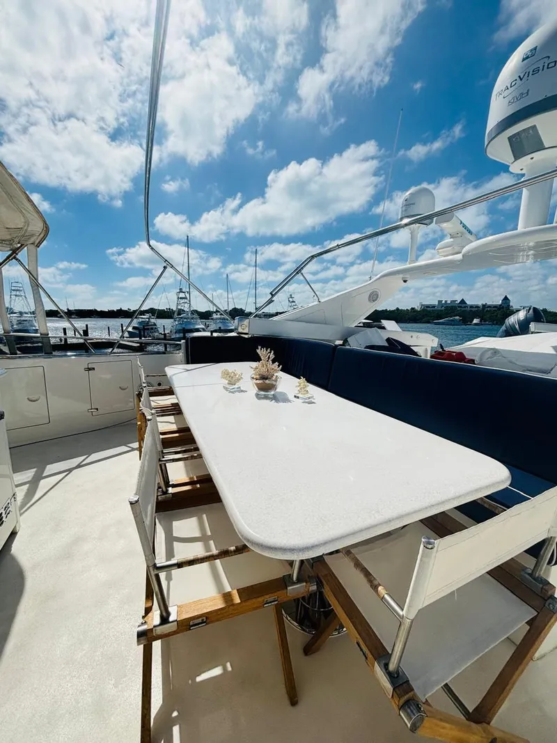 Slide: The Image of Spacious deck of 2000 Falcon Motoryacht with elegant outdoor dining setup. - 9
