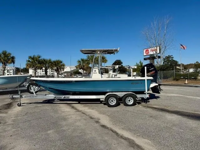 Slide: The Image of 2021 Bulls Bay 2200 boat on trailer, parked outdoors under clear blue sky. - 1