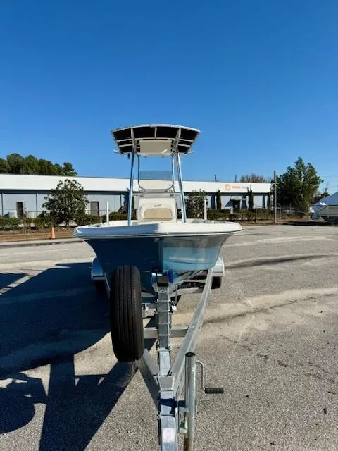 Slide: The Image of 2021 Bulls Bay 2200 boat on trailer, parked outdoors under clear blue sky. - 6