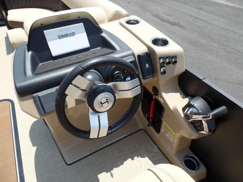 Slide: The Image of 2025 Harris SUNLINER SP 250 boat dashboard with steering wheel and controls. - 10