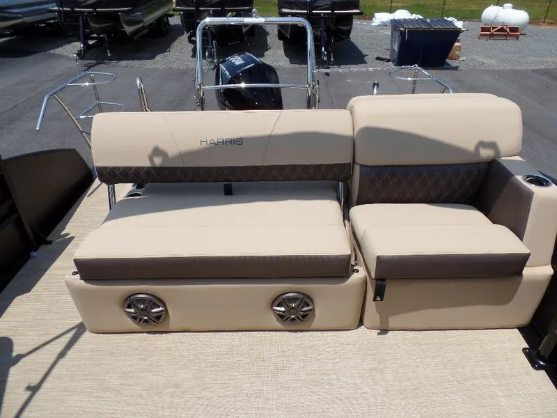 Slide: The Image of 2025 Harris SUNLINER SP 250 boat seating with beige upholstery and integrated speakers. - 11