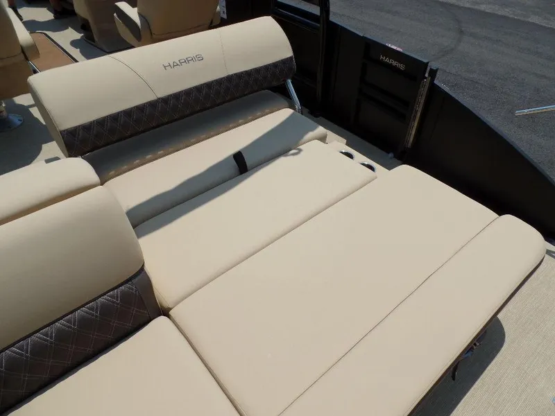 Slide: The Image of 2025 Harris SUNLINER SP 250 boat interior with beige and brown seating. - 13