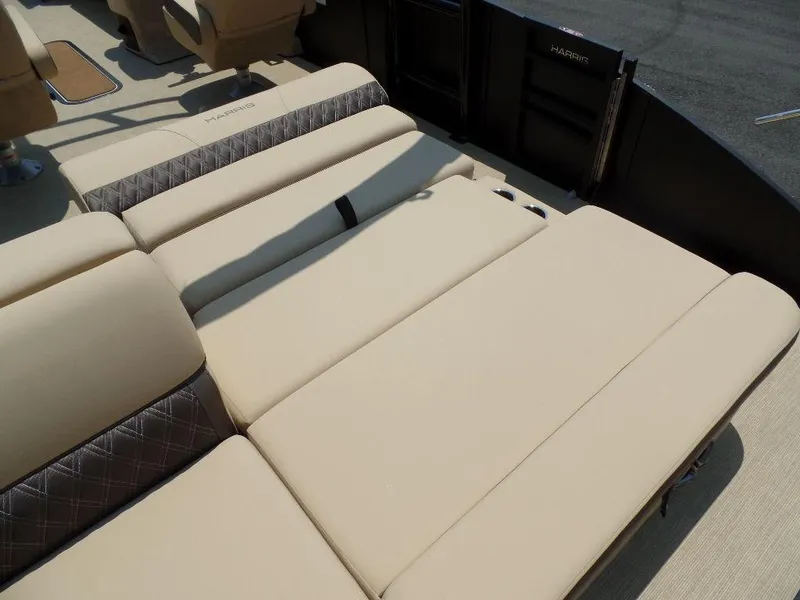 Slide: The Image of 2025 Harris SUNLINER SP 250 boat interior with beige seating and diamond-patterned accents. - 14