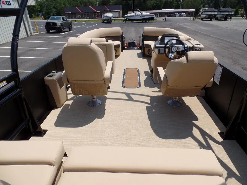 Slide: The Image of 2025 Harris SUNLINER SP 250 pontoon boat interior with beige seating and steering console. - 15